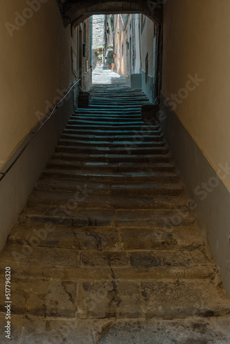 View to ancient arch and passage with massive stone stairs leading to courtyard