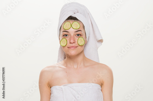 beauty portrait of a cheerful girl with a towel on her head isolated.Facial skin care and health concept.close-up on a white background. girl holding a glass holding an apple brushing her teeth making
