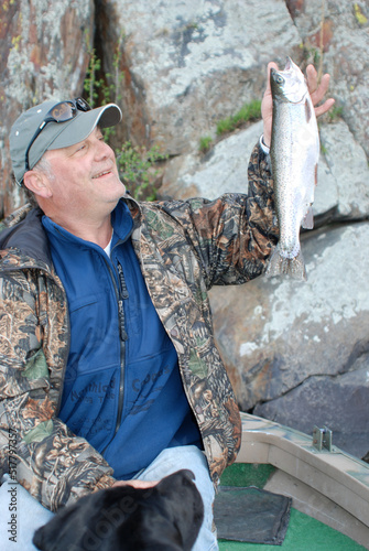 An angler with a rainbow trout 
