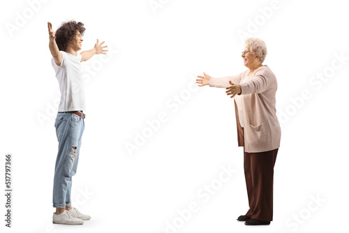 Happy young man meeting an elderly woman with arms wide open