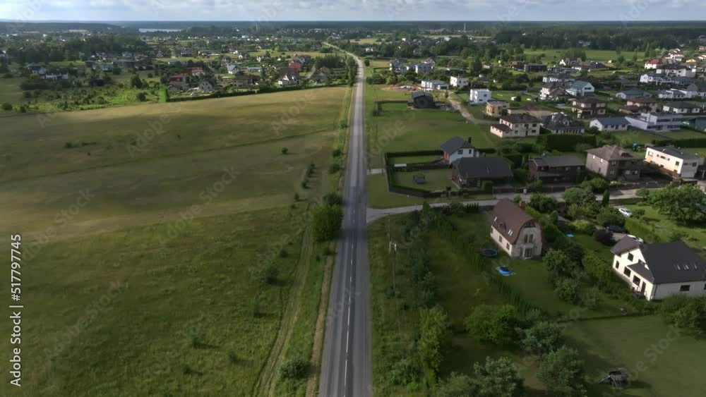 Aerial view of the highway going through the green fields and forests. Traffic moving down the highway in Europe. Aerial view of the highway going through the green fields and forests. Traffic moving down the highway in Europe.