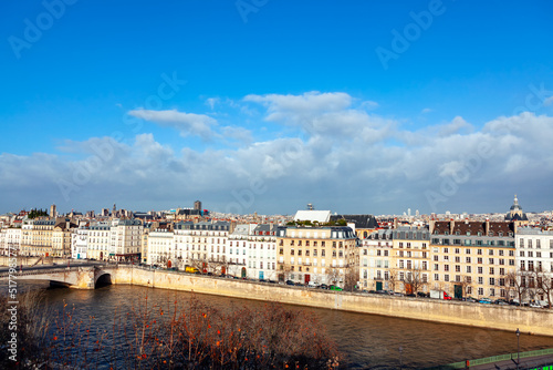 Paris residential houses situated at Seine river coast . Riverside buildings and bridge in Paris France 