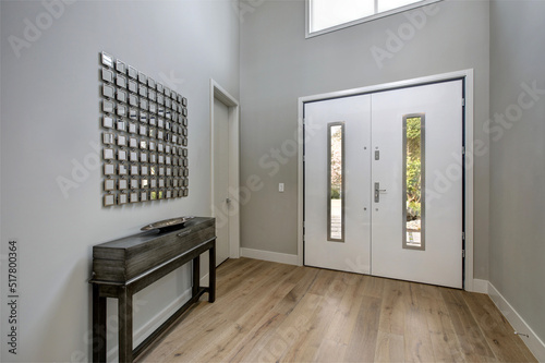 White front door opens to a contemporary foyer