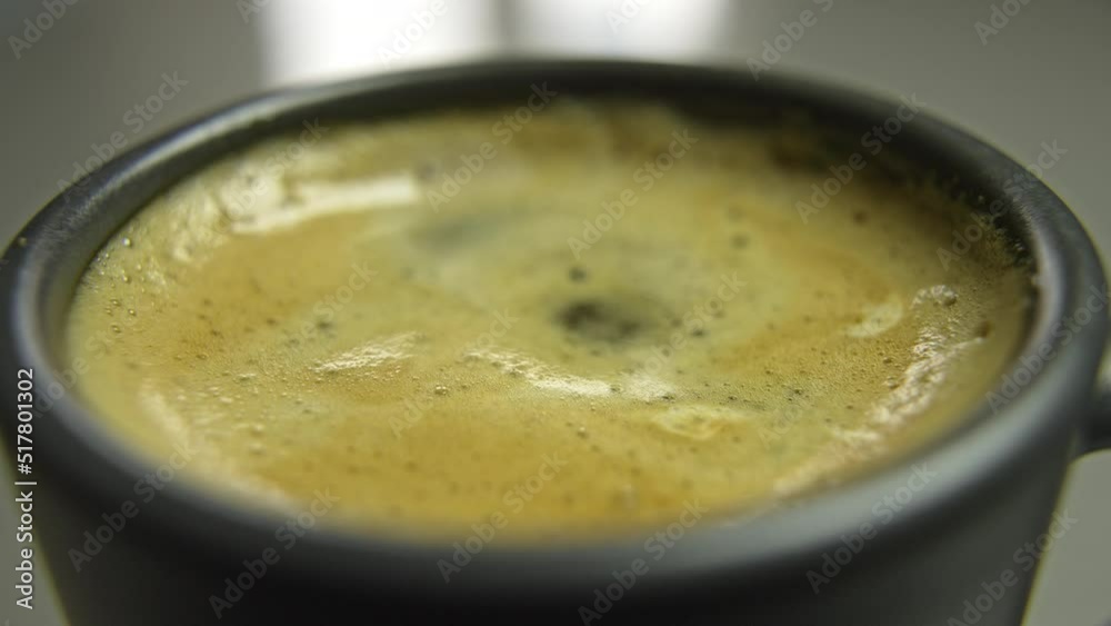 Falling drops into a cup of cappuccino. High quality 4k footage Falling drops into a cup of cappuccino. High quality 4k footage