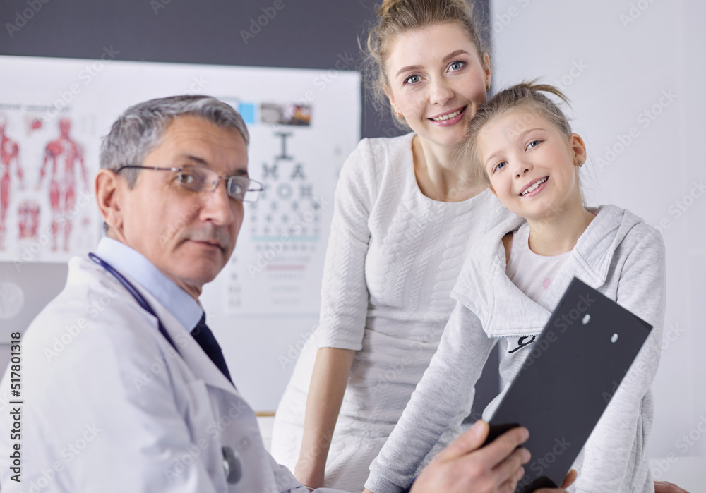 Little girl with her mother at a doctor on consultation Little girl with her mother at a doctor on consultation