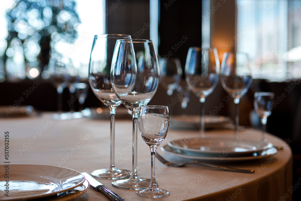 Empty wine glasses are on the table in the restaurant. Empty wine glasses are on the table in the restaurant.
