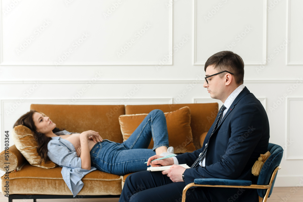 Woman patient with male psychologist consulting and doing psychotherapy with doctor in clinic. Psychiatrist concept Woman patient with male psychologist consulting and doing psychotherapy with doctor in clinic. Psychiatrist concept