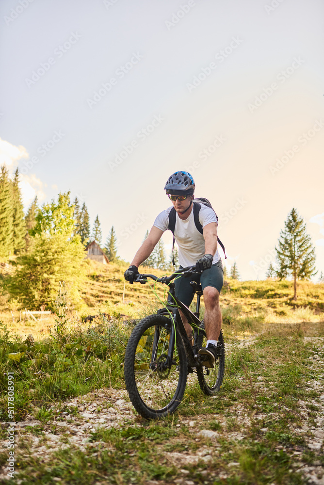 A cyclist rides a bike on extreme and dangerous forest roads. Selective focus