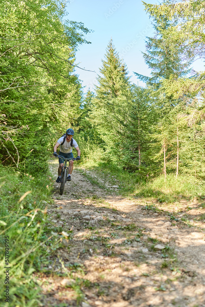 A cyclist rides a bike on extreme and dangerous forest roads. Selective focus