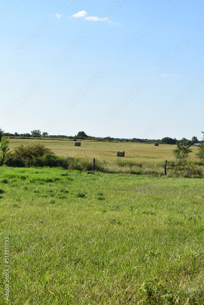 Hay Bales in the Distance in a Rural Farm Field