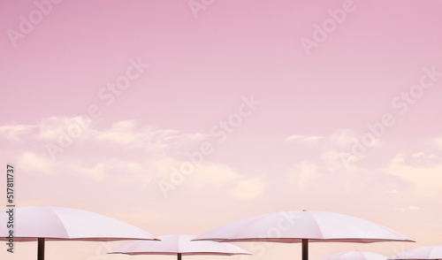 Minimal pink umbrellas against pink sky