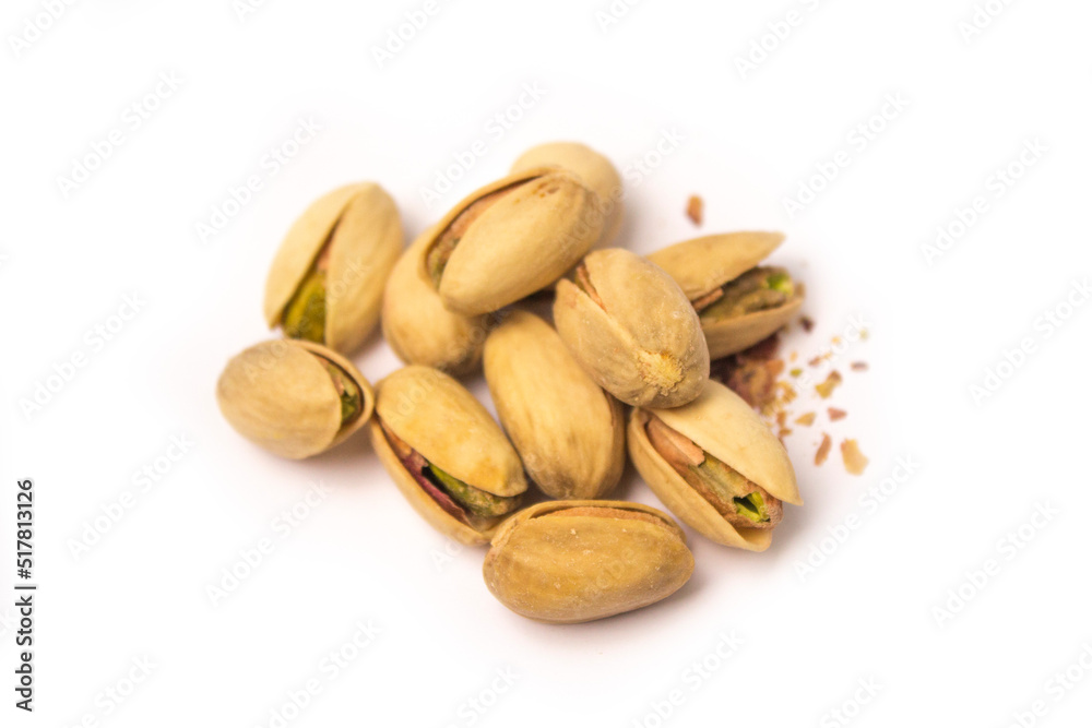 Obraz premium some pistachios are lying on a white background