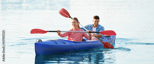 Young couple kayaking in ri...