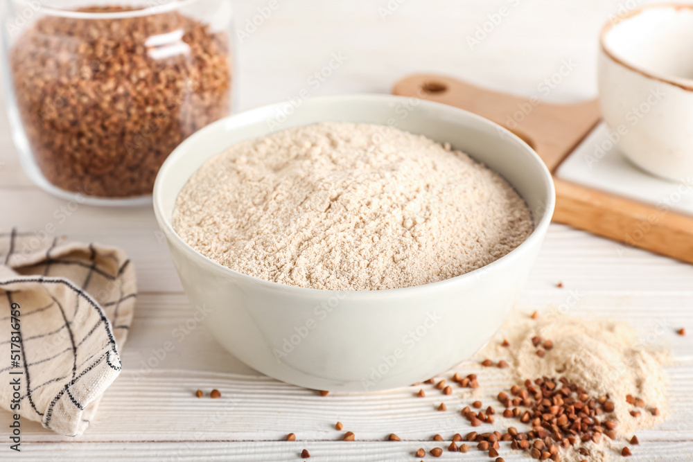 Bowl of buckwheat flour on white wooden background, closeup Bowl of buckwheat flour on white wooden background, closeup