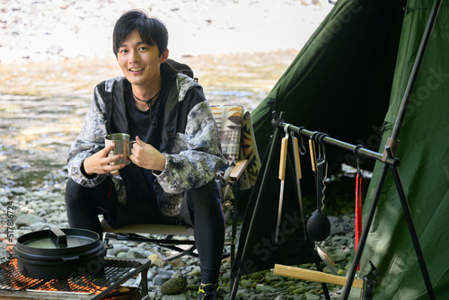 Men's solo camping for all seasons, looking at the camera © kapinon