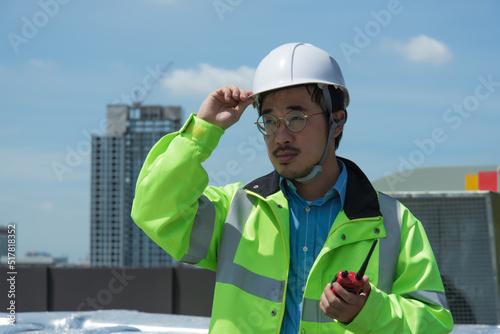 portrait of a engineer. construction worker on site. Couple worker standing and disscuss job with building on background. construction worker on site. male worker standing and disscuss job with buildi photo