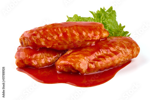 Marinated Buffalo chicken wings in red sauce with lettuce salad leaf, isolated on white background.