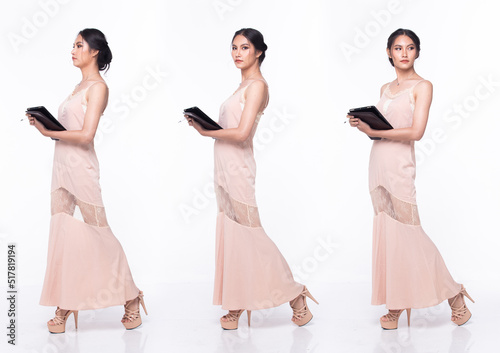 Full length body of Asian beautiful woman wear Pink evening sequin gown  working digital tablet