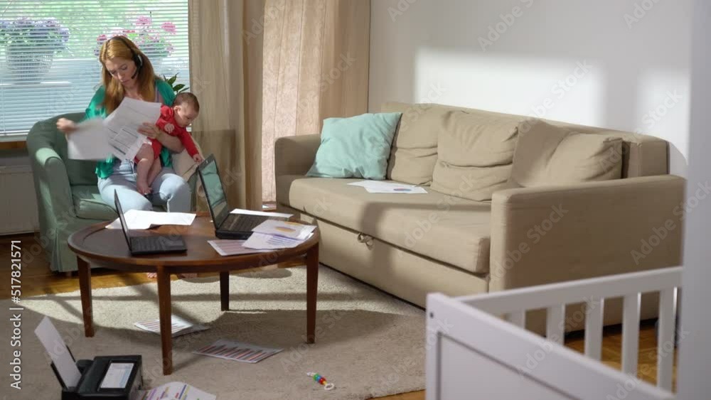 Young mother with baby working from home. A freelance single mom with newborn making a video call and working with documents at home. Remote job, multi-tasking, maternity leave and family. Young mother with baby working from home. A freelance single mom with newborn making a video call and working with documents at home. Remote job, multi-tasking, maternity leave and family.