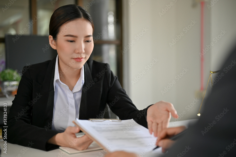 Beautiful Asian female lawyer or business law consultant having a meeting with her client. Beautiful Asian female lawyer or business law consultant having a meeting with her client.