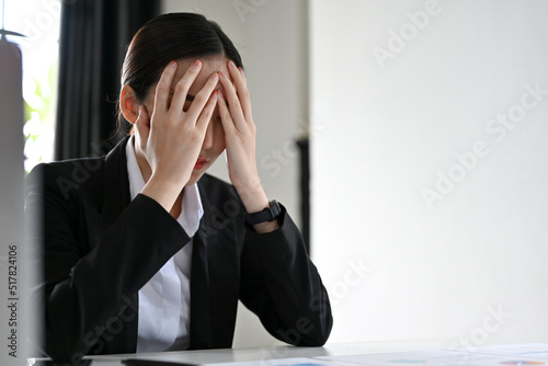 Stressed young Asian businesswoman having a mental health problem