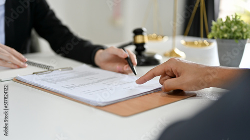 Professional female lawyer counselling the legal to her client. cropped image