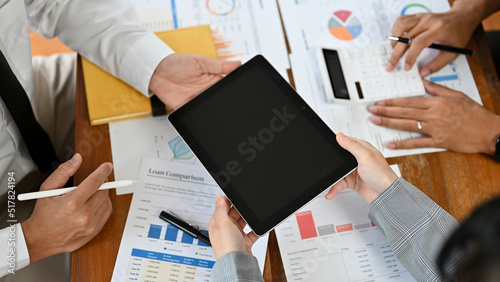 Overhead, A businesspeople using a digital tablet and analysing financial data