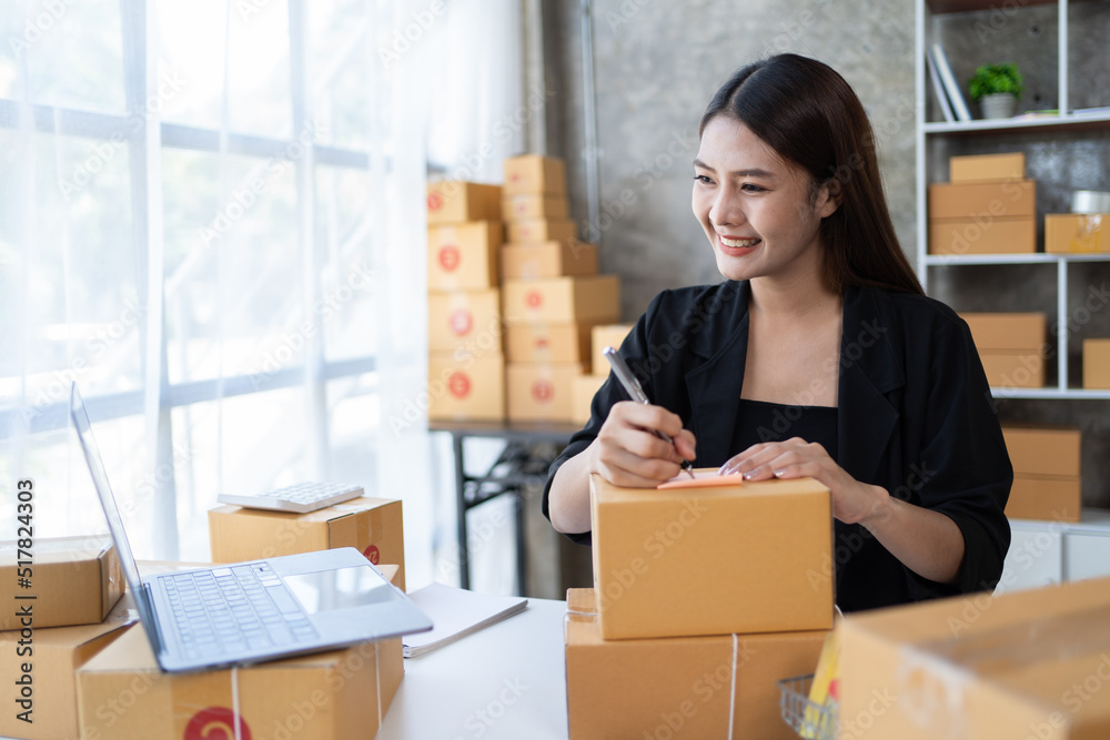Starting small businesses SME owners female entrepreneurs check online orders to prepare to pack the boxes, sell to customers, sme business ideas online. Starting small businesses SME owners female entrepreneurs check online orders to prepare to pack the boxes, sell to customers, sme business ideas online.