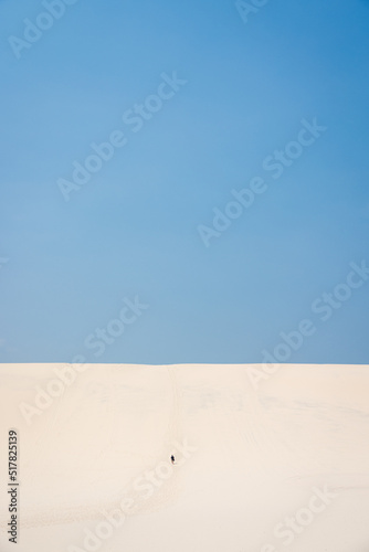 Walking up giant sand dune on Fraser Island K'Gari, Queensland Australia