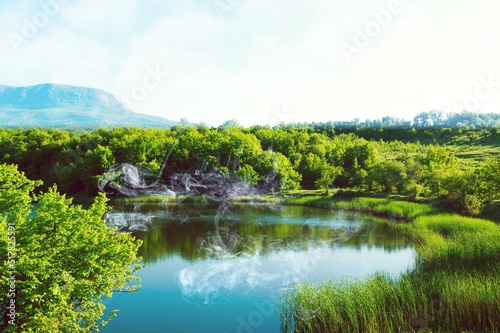 A beautiful lake in a summer green forest.Summer green lake view. Summer forest lake landscape