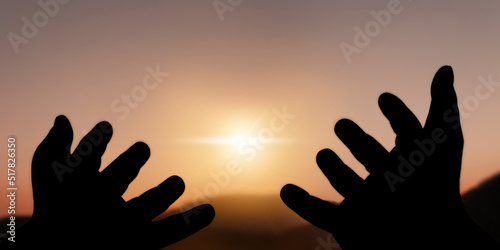 Concept of Freedom and International Day of Peace. Silhouette of calm freed hands in the sky at sunrise, morning, beautiful nature.Freedom, hope, independence, prayer, relaxation.