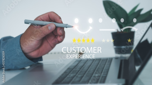 Customer Service Assessment Concept. Businessman pressing face smiley face pen to display emoticons on virtual screens  surveys  polls  questionnaires for user experience or customer satisfaction .