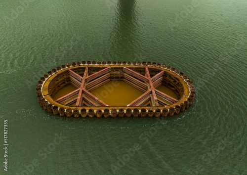Overhead view of coffer dam holding back river water on bridge construction site