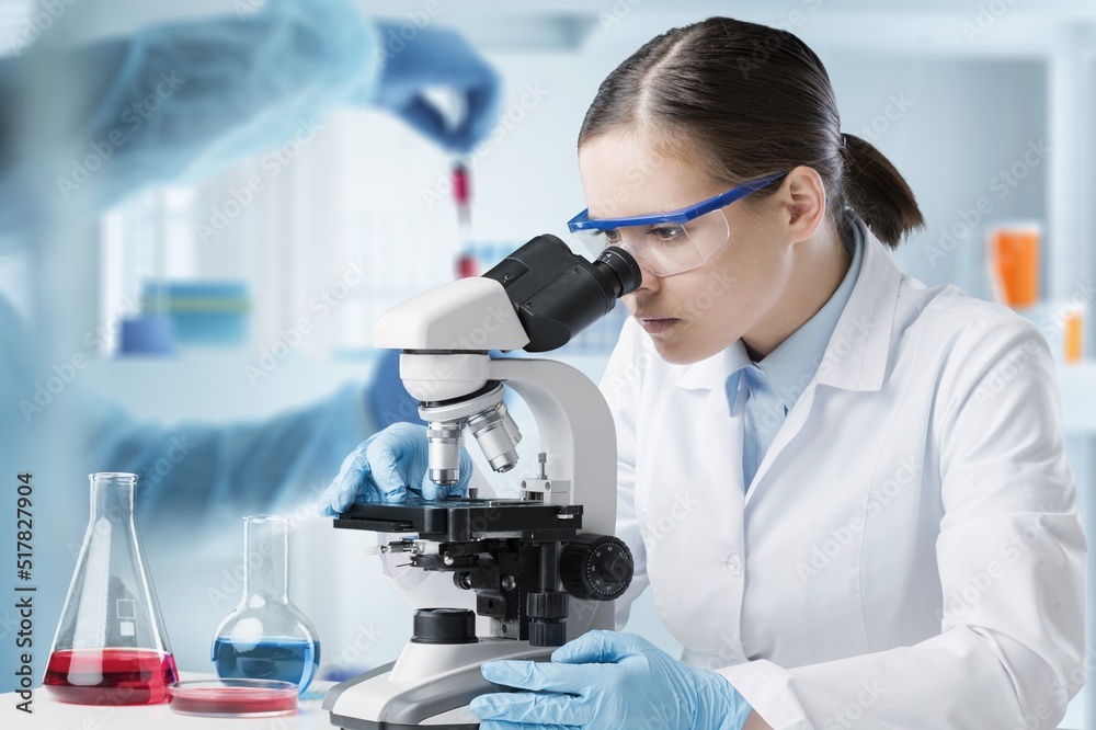 Students working in the clinical laboratory, a researcher is using a microscope, scientific research concept Students working in the clinical laboratory, a researcher is using a microscope, scientific research concept