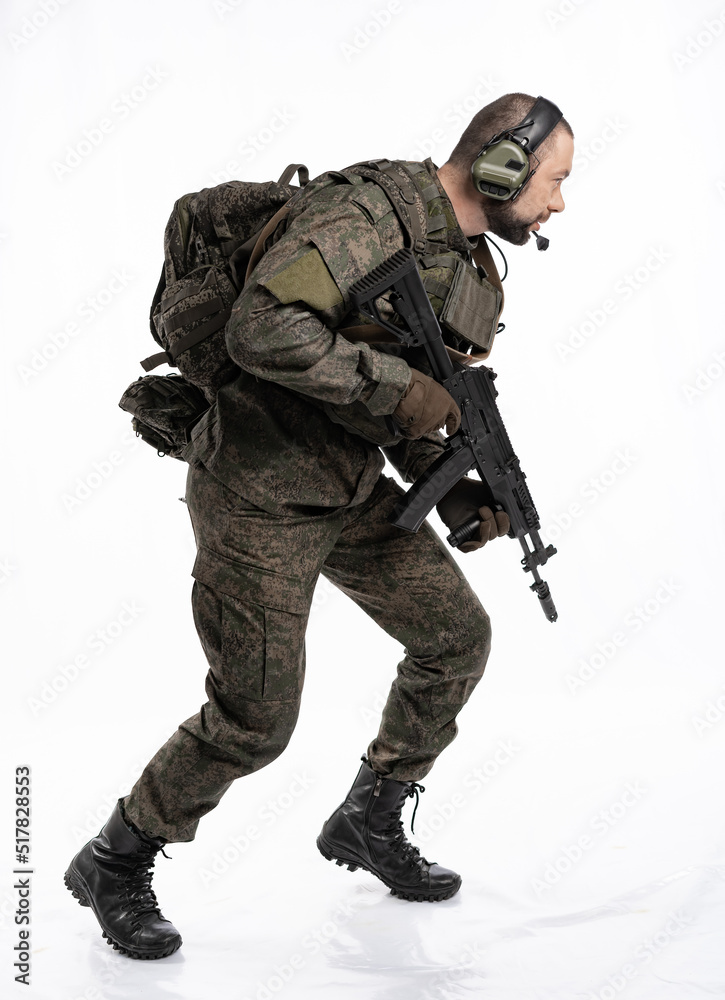 soldier in the studio on a white background. a man in military uniform with a rifle or machine gun. military or airball player soldier in the studio on a white background. a man in military uniform with a rifle or machine gun. military or airball player