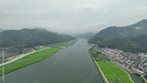 Slow aerial pullback on Maruyama River through Kinosaki and unfinished bridge  photo