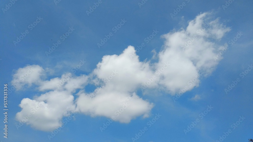 White clouds against a blue sky background, a beautiful view during the day. White clouds against a blue sky background, a beautiful view during the day.