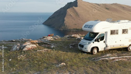  Three people spending time together on vacation near modern rv camper van.
