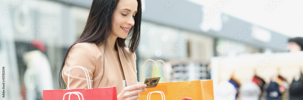Woman shopaholic make order via smartphone and pay with credit card Woman shopaholic make order via smartphone and pay with credit card