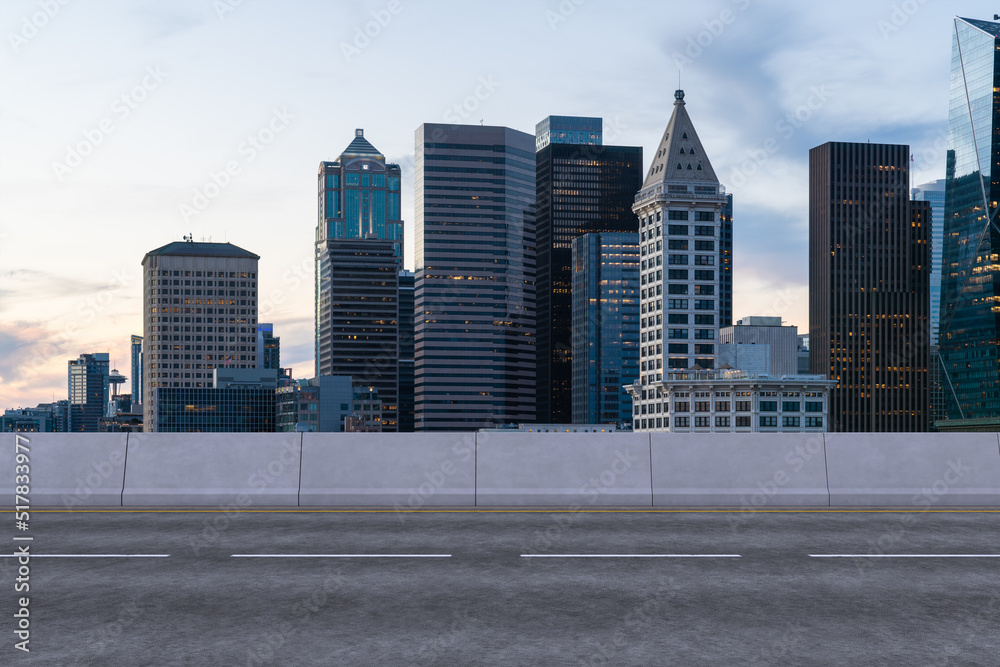 Empty urban asphalt road exterior with city buildings background. New modern highway concrete construction. Concept way to success. Transportation logistic industry fast delivery. Seattle. USA. Empty urban asphalt road exterior with city buildings background. New modern highway concrete construction. Concept way to success. Transportation logistic industry fast delivery. Seattle. USA.