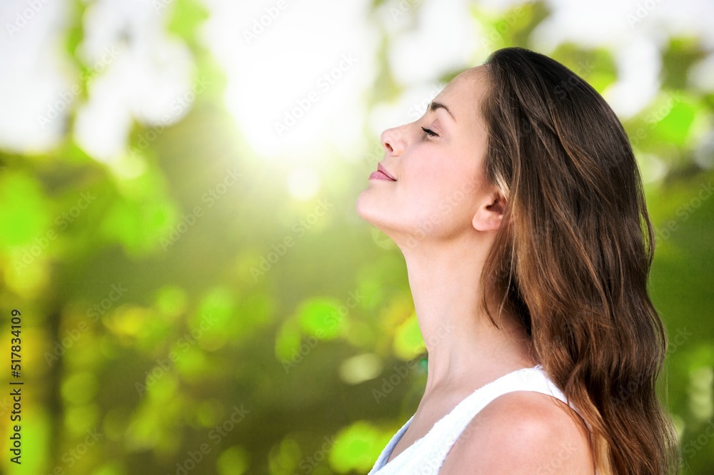 Portrait of a young woman breathing fresh air in a forest Portrait of a young woman breathing fresh air in a forest
