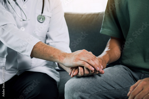 Doctor is holding the hand of the patient by giving him confidence in the doctor.