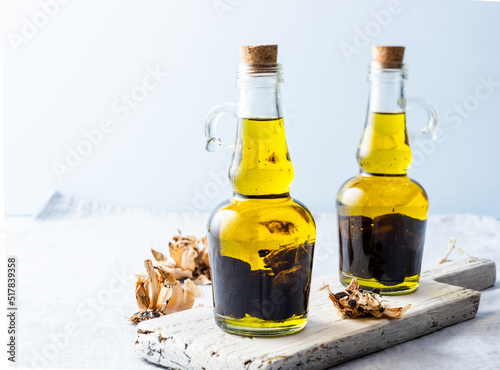 Olive oil bottles on wooden board photo