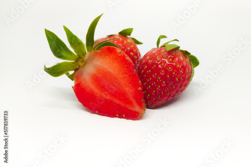 whole and sliced fresh strawberries isolated on white background
