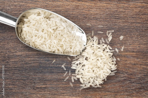 A resh white rice in big spoon photo