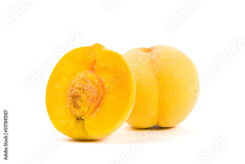 Yellow peach with half isolated on white background.