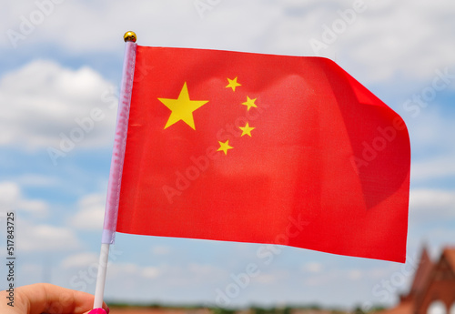 national flag of China red color and yellow stars close up photo