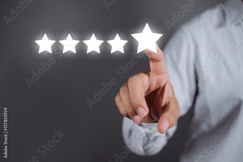 Businessman pointing a five-star symbol to increase the company's rating, customer service and Satisfaction, positive customer Experience feedback and review