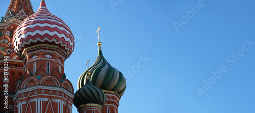 Ancient and medieval golden Domes with golden crosses on the Orthodox Church against the blue sky with copy space. Byzantine style. Banner, postcard or poster of a religious theme.