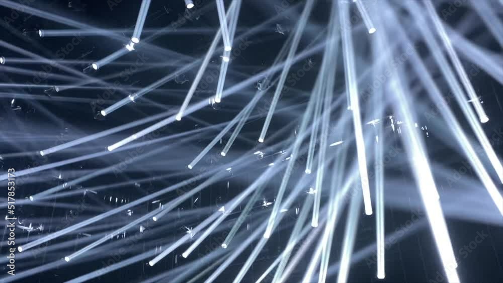 Dozens of sharp white light rays move through a dark black painted room in a club-like setup. An amazing light show and club vibe and party feelings. 